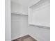 Empty walk-in closet featuring built in shelves and hanging rods at 14247 W Bronco Trl, Surprise, AZ 85387