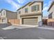 Two-story home with two car garage and desert landscaping at 14247 W Bronco Trl, Surprise, AZ 85387