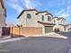 Two-story home with desert landscaping, brick wall, and two car garage at 14247 W Bronco Trl, Surprise, AZ 85387