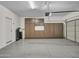 Spacious garage with epoxy flooring, built-in cabinets, and ample storage space at 14247 W Bronco Trl, Surprise, AZ 85387