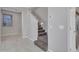 Hallway with tiled floors and a carpeted staircase that leads upstairs at 14247 W Bronco Trl, Surprise, AZ 85387