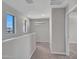 Well lit hallway with carpet flooring and windows providing natural light at 14247 W Bronco Trl, Surprise, AZ 85387