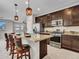 The kitchen island features granite countertops and dark cabinetry, creating an inviting space at 14247 W Bronco Trl, Surprise, AZ 85387