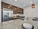 Kitchen features granite countertops, stainless steel appliances, and dark cabinets at 14247 W Bronco Trl, Surprise, AZ 85387
