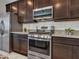Modern kitchen boasts granite countertops, stainless appliances, and ample cabinet space at 14247 W Bronco Trl, Surprise, AZ 85387
