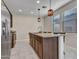 Kitchen island with granite countertop, stainless steel appliances, tile floors at 14247 W Bronco Trl, Surprise, AZ 85387