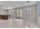 Spacious living area with tile flooring, sliding door, and a view of the kitchen area at 14247 W Bronco Trl, Surprise, AZ 85387