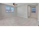 Bright living room features tile flooring, neutral paint, and windows letting in natural light at 14247 W Bronco Trl, Surprise, AZ 85387