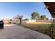 Backyard featuring mature trees and a grassy lawn, with concrete patio at 14251 N 182Nd Ave, Surprise, AZ 85388