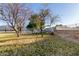 Large backyard features metal fencing, mature trees, and plenty of space at 14251 N 182Nd Ave, Surprise, AZ 85388