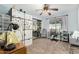 Bright bedroom featuring carpeted floor, a ceiling fan, and a closet at 14251 N 182Nd Ave, Surprise, AZ 85388