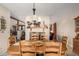 Dining room with a decorative chandelier and fireplace, providing ample natural light at 14251 N 182Nd Ave, Surprise, AZ 85388