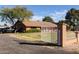 Exterior shot of single Gathering home with gated entrance and well-kept lawn at 14251 N 182Nd Ave, Surprise, AZ 85388