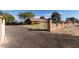Exterior shot of a charming home with a gated entrance and gravel front yard at 14251 N 182Nd Ave, Surprise, AZ 85388