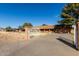 A beautiful home with a gated entrance and long driveway, nestled among mature trees in a well maintained yard at 14251 N 182Nd Ave, Surprise, AZ 85388