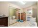 Bright laundry room with tile flooring, mirrored closet doors, and access to the backyard at 14251 N 182Nd Ave, Surprise, AZ 85388
