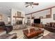 Spacious living room featuring a fireplace, wooden beams, and leather seating at 14251 N 182Nd Ave, Surprise, AZ 85388