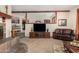 Cozy living room with fireplace, carpet, and a comfortable leather couch at 14251 N 182Nd Ave, Surprise, AZ 85388