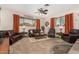 Spacious living room with comfortable leather furniture, neutral carpeting, and lots of natural light at 14251 N 182Nd Ave, Surprise, AZ 85388