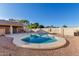 Sparkling backyard pool with a unique shape, a spacious deck, and mature landscaping at 14251 N 182Nd Ave, Surprise, AZ 85388