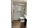 A bathroom features a walk-in shower with a safety bar and vinyl plank flooring at 15601 N 27Th St # 5, Phoenix, AZ 85032