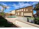 Backyard oasis with pool, spa, artificial grass, and covered patio, perfect for entertaining at 17641 W Corrine Dr, Surprise, AZ 85388