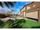 Wonderful backyard featuring a pool and spa surrounded by lush landscaping and artificial grass at 17641 W Corrine Dr, Surprise, AZ 85388