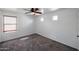This bedroom boasts natural light, a ceiling fan, and ample space at 17641 W Corrine Dr, Surprise, AZ 85388