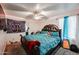 A bedroom showcasing unique decor, a ceiling fan, and plenty of space at 17641 W Corrine Dr, Surprise, AZ 85388