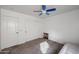 A bedroom with carpeted floors, ceiling fan and two doors at 17641 W Corrine Dr, Surprise, AZ 85388