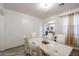 Bright dining room features a modern marble table, decor, and modern light fixture at 17641 W Corrine Dr, Surprise, AZ 85388