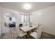 Bright dining room features a modern table, decor, and modern light fixture at 17641 W Corrine Dr, Surprise, AZ 85388