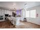 Spacious kitchen boasts a large island with seating, modern appliances, and ample cabinet space, perfect for entertaining at 17641 W Corrine Dr, Surprise, AZ 85388