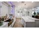 Bright kitchen features a large island with quartz countertops, stainless steel appliances, and custom cabinets with accent lighting at 17641 W Corrine Dr, Surprise, AZ 85388