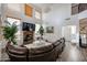 Bright living room features a fireplace, tall ceilings, and comfortable seating at 17641 W Corrine Dr, Surprise, AZ 85388