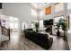 Bright living room with fireplace, vaulted ceiling, and staircase access at 17641 W Corrine Dr, Surprise, AZ 85388