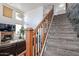 Inviting living room featuring a cozy fireplace, chandelier, and staircase leading upstairs at 17641 W Corrine Dr, Surprise, AZ 85388