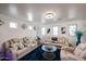 Bright living room features plush seating, modern lighting, and stylish decor at 17641 W Corrine Dr, Surprise, AZ 85388