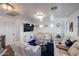 Comfortable living room with plush seating, modern lighting, a large screen television, and stylish decor at 17641 W Corrine Dr, Surprise, AZ 85388