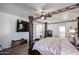 Bedroom with carpet, a TV, and an en suite bath at 17641 W Corrine Dr, Surprise, AZ 85388