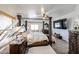 Bedroom with an ornate four-poster bed, a ceiling fan, and a TV at 17641 W Corrine Dr, Surprise, AZ 85388