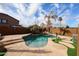 Inviting backyard pool with rock waterfall feature and lush landscaping at 17641 W Corrine Dr, Surprise, AZ 85388