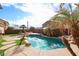 Lush backyard oasis, highlighting the sparkling pool surrounded by palm trees at 17641 W Corrine Dr, Surprise, AZ 85388