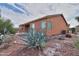 Backyard view of home, landscaping and covered patio at 19973 N Monte Ln, Maricopa, AZ 85138