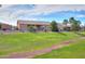 Property featuring a well-maintained yard with view of neighboring community walking path at 19973 N Monte Ln, Maricopa, AZ 85138