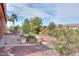 Outdoor patio with greenery, landscaping, and desert foliage, creating a serene and inviting space at 19973 N Monte Ln, Maricopa, AZ 85138