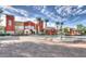 Elegant clubhouse featuring a beautiful fountain, lush landscaping, and ample parking at 19973 N Monte Ln, Maricopa, AZ 85138