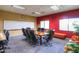 This bright conference room has a large table and comfortable seating for meetings and presentations at 19973 N Monte Ln, Maricopa, AZ 85138