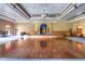 Large community event space includes a wooden dance floor, stage, and seating area at 19973 N Monte Ln, Maricopa, AZ 85138