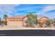 Charming home featuring a two-car garage and desert landscaping at 19973 N Monte Ln, Maricopa, AZ 85138